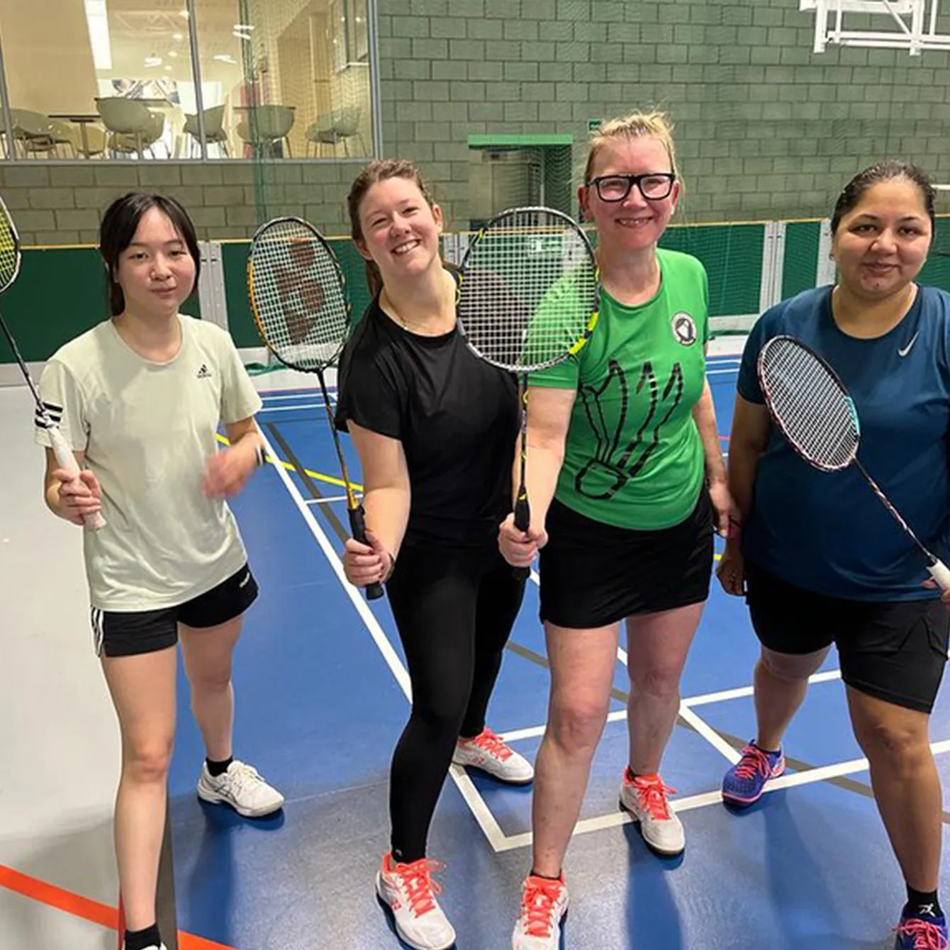 Four ladies from Broadlands Badminton club posing for a photo after a league match.