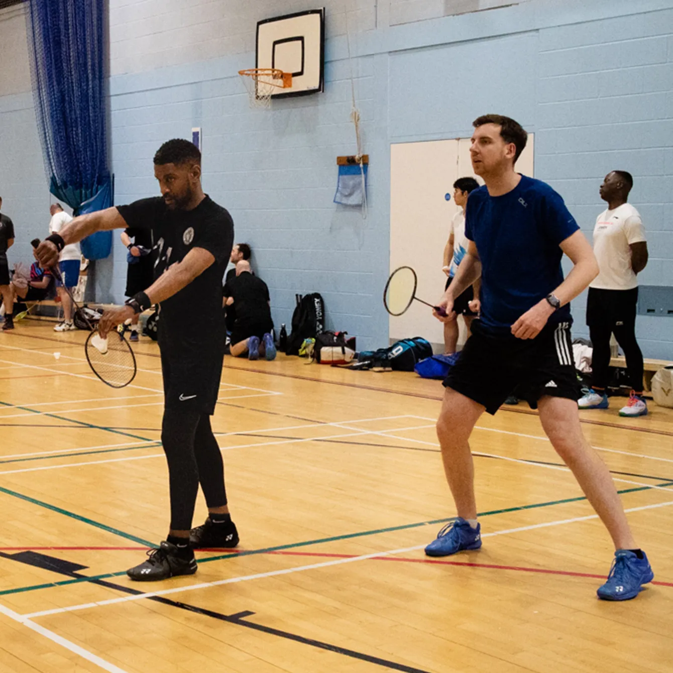 Two broadlands badminton club players getting ready to start a rally.